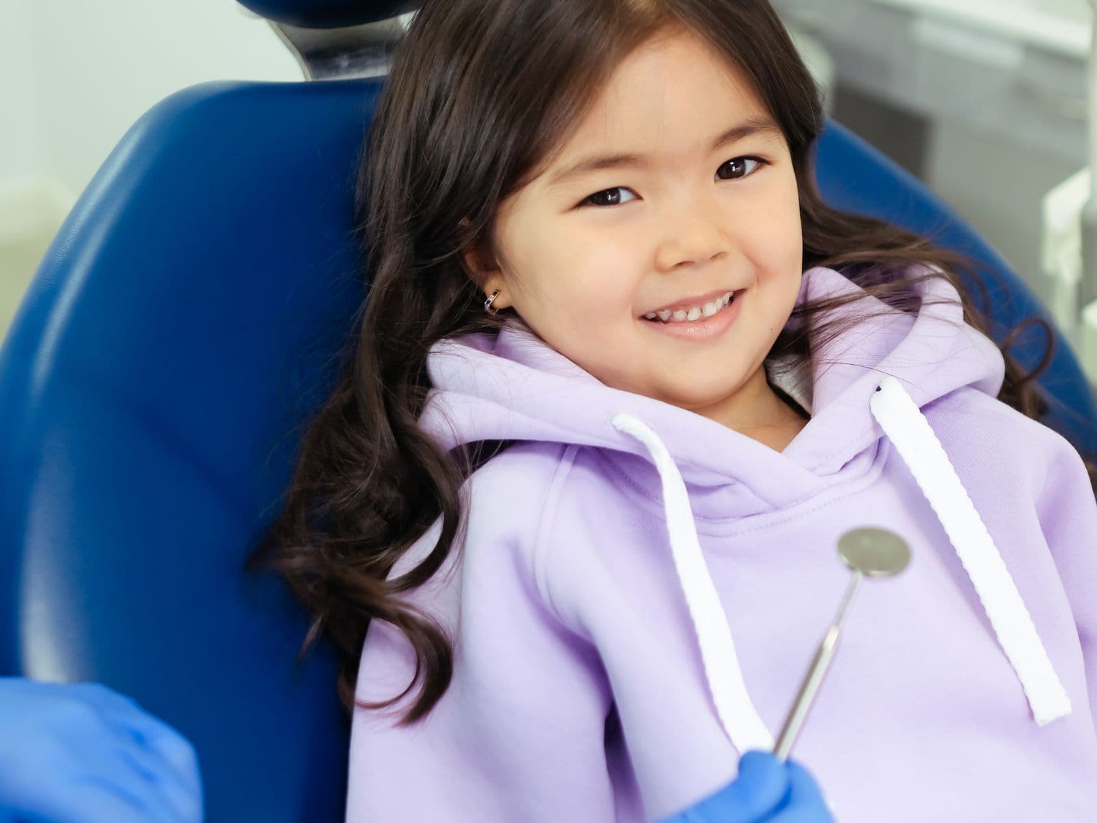 A child smiling during a friendly dental visit at Fairfield Dental Centre